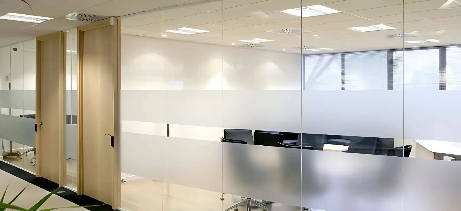 Series of glass walls separating different conference rooms. Only doors are opaque (made of wood)...